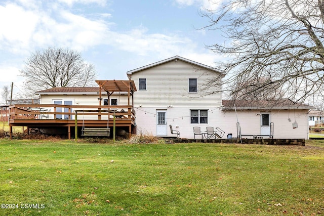 back of property with a yard and a deck