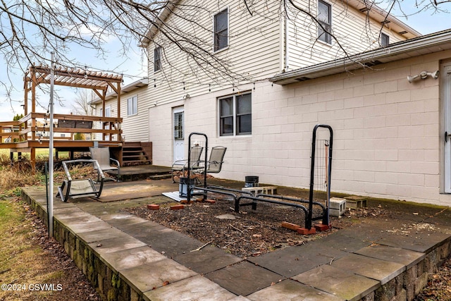 exterior space with a deck, a pergola, and a patio