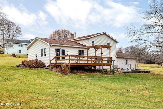 rear view of property with a pergola, a yard, and a deck