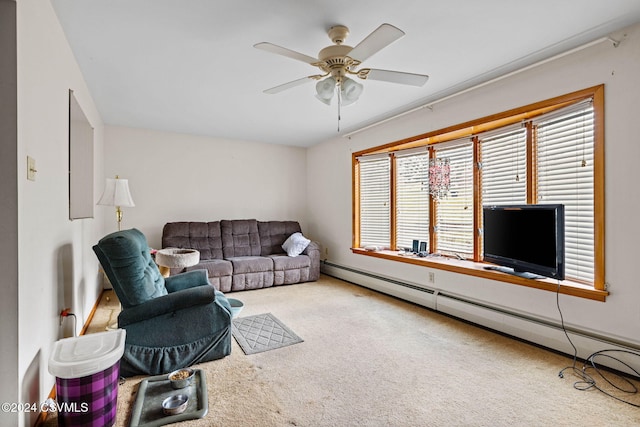 carpeted living room with ceiling fan and a baseboard heating unit