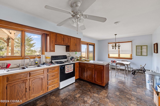 kitchen with white range with electric cooktop, sink, hanging light fixtures, and a wealth of natural light