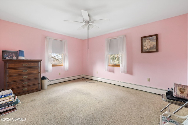 carpeted bedroom with multiple windows, a baseboard heating unit, and ceiling fan