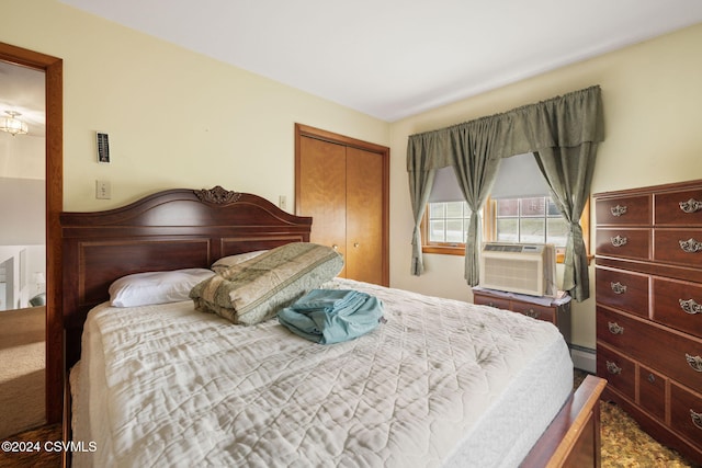 bedroom featuring cooling unit, a baseboard radiator, and a closet