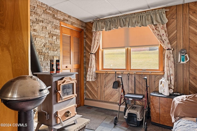 miscellaneous room featuring wood walls and a baseboard radiator