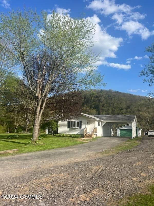 ranch-style home with a carport and a front yard