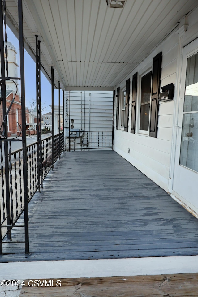 wooden terrace featuring covered porch