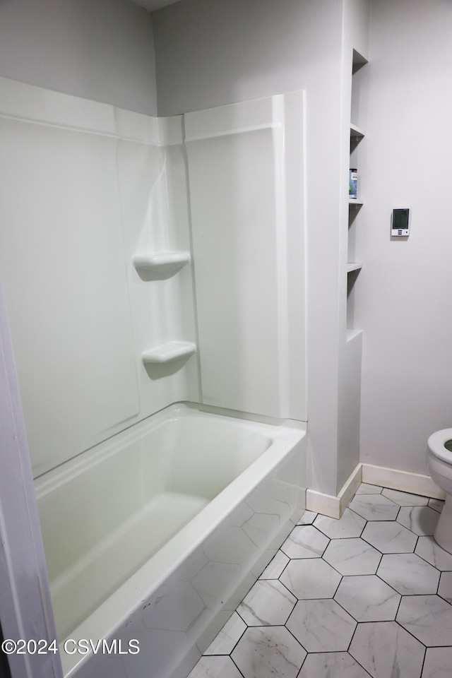 bathroom featuring bathtub / shower combination, tile patterned flooring, and toilet