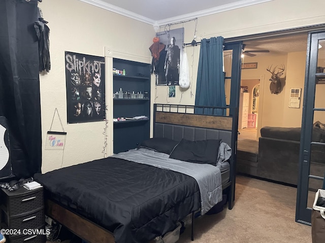 carpeted bedroom with ornamental molding