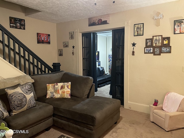 carpeted living room with a textured ceiling