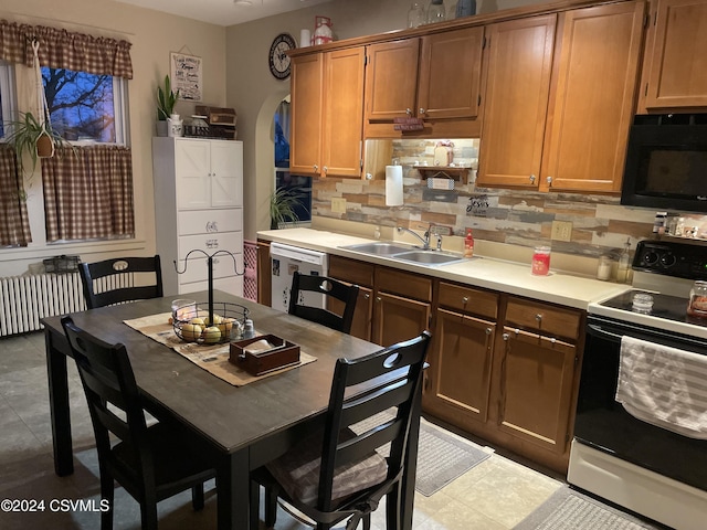 kitchen featuring dishwasher, sink, tasteful backsplash, electric stove, and light tile patterned floors