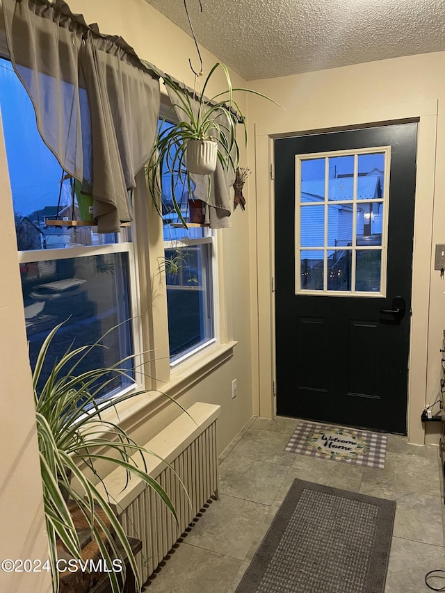 entryway with a textured ceiling