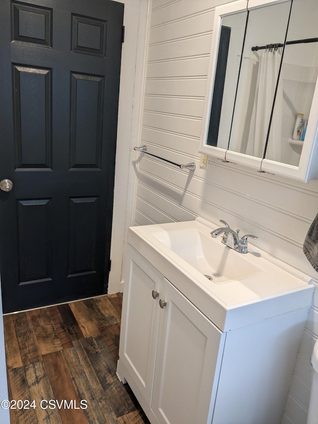 bathroom featuring walk in shower, vanity, and hardwood / wood-style flooring