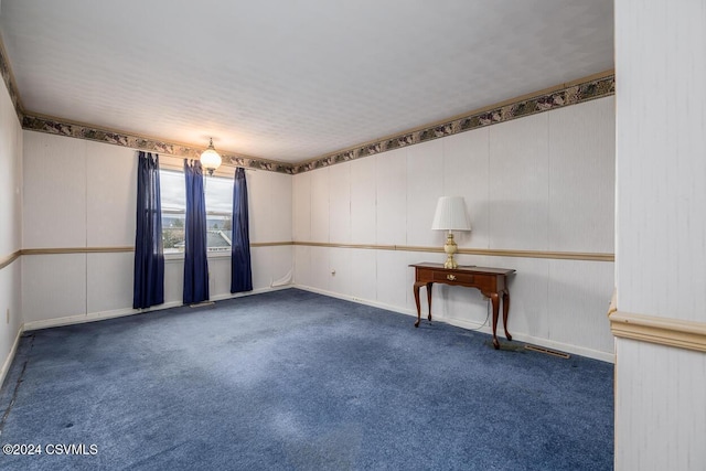 spare room with dark colored carpet