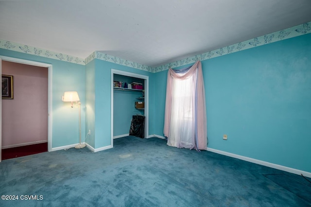 unfurnished bedroom featuring carpet and a closet