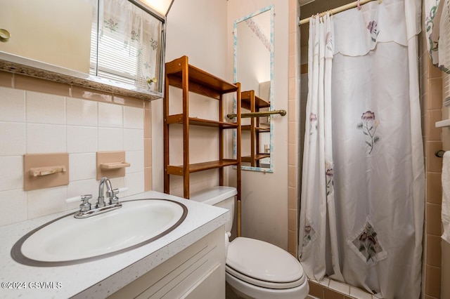 bathroom featuring vanity, backsplash, toilet, and walk in shower