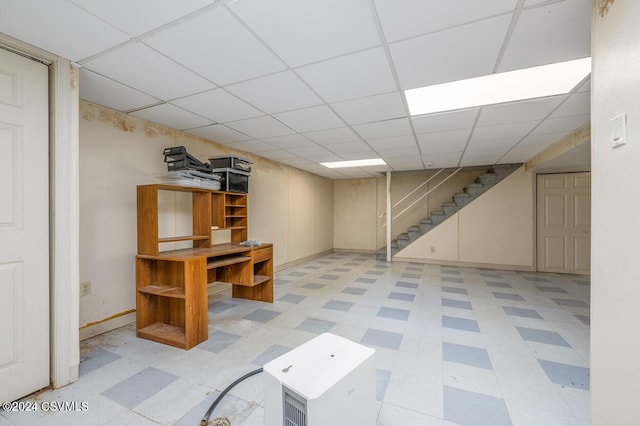 basement featuring a paneled ceiling