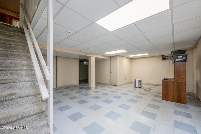 basement with a paneled ceiling