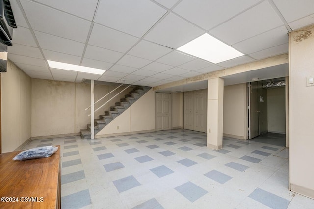 basement with a paneled ceiling