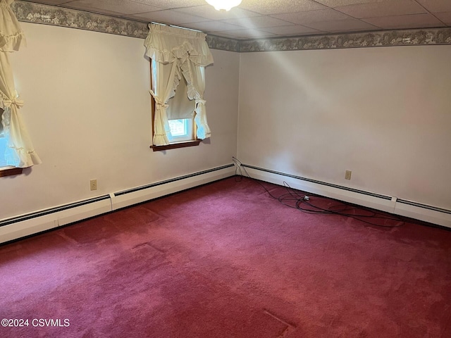 carpeted spare room with a paneled ceiling