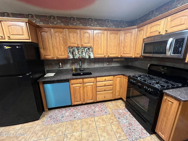 kitchen featuring black appliances, decorative backsplash, light tile patterned flooring, and sink