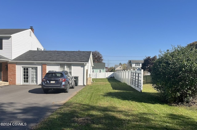 view of side of property with a yard