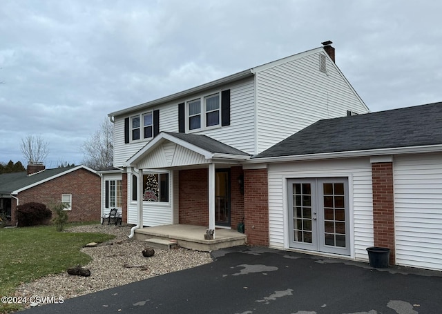 view of front property with a front yard and french doors