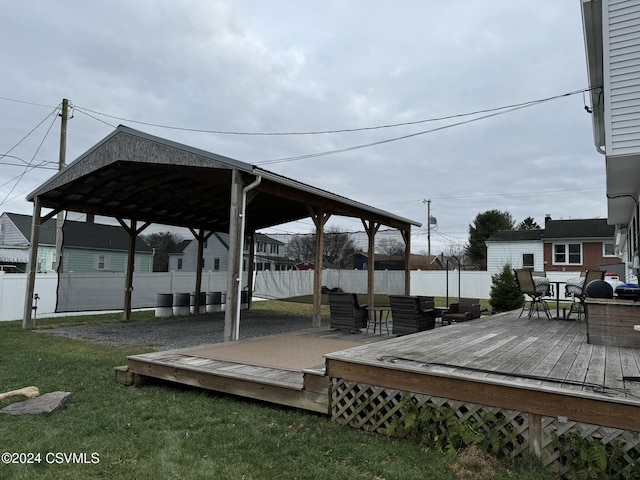 wooden terrace featuring a yard