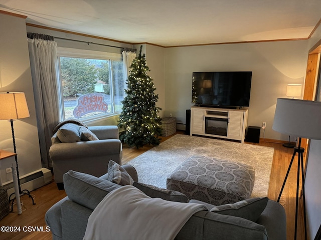 living room with hardwood / wood-style floors, a baseboard heating unit, and ornamental molding