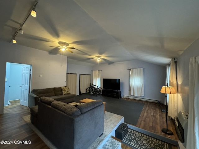 living room featuring track lighting, lofted ceiling, dark wood-type flooring, and a baseboard heating unit