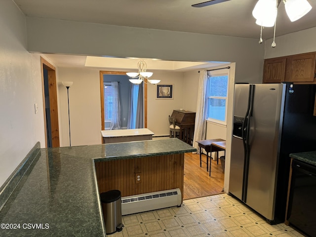 kitchen with pendant lighting, ceiling fan with notable chandelier, light hardwood / wood-style flooring, a baseboard radiator, and stainless steel fridge with ice dispenser