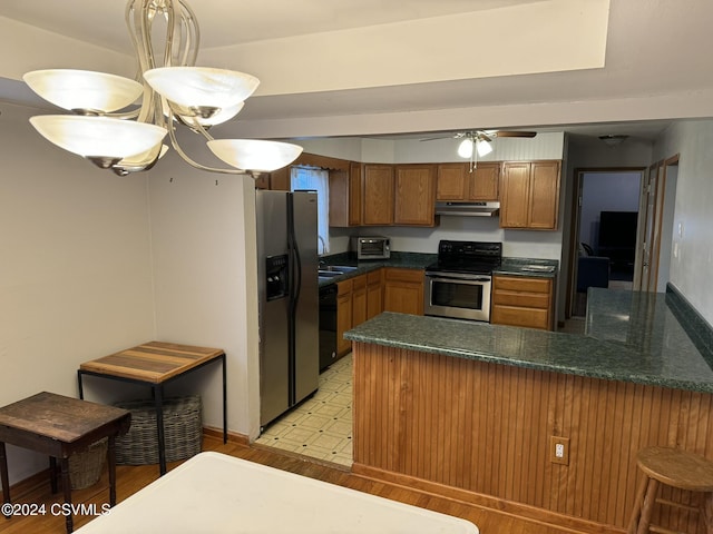 kitchen with ceiling fan, sink, hanging light fixtures, kitchen peninsula, and appliances with stainless steel finishes