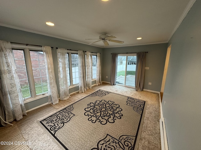 entryway with baseboard heating, a wealth of natural light, ornamental molding, and ceiling fan