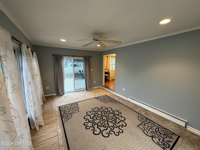 empty room featuring ceiling fan, crown molding, and a baseboard radiator