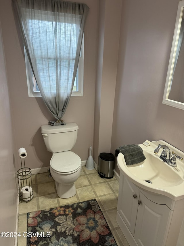 bathroom with tile patterned floors, vanity, and toilet