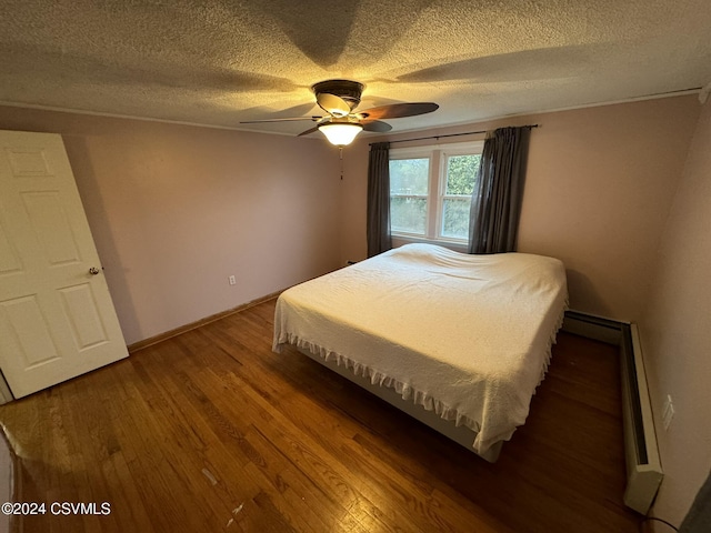 bedroom with hardwood / wood-style flooring, ceiling fan, and a textured ceiling