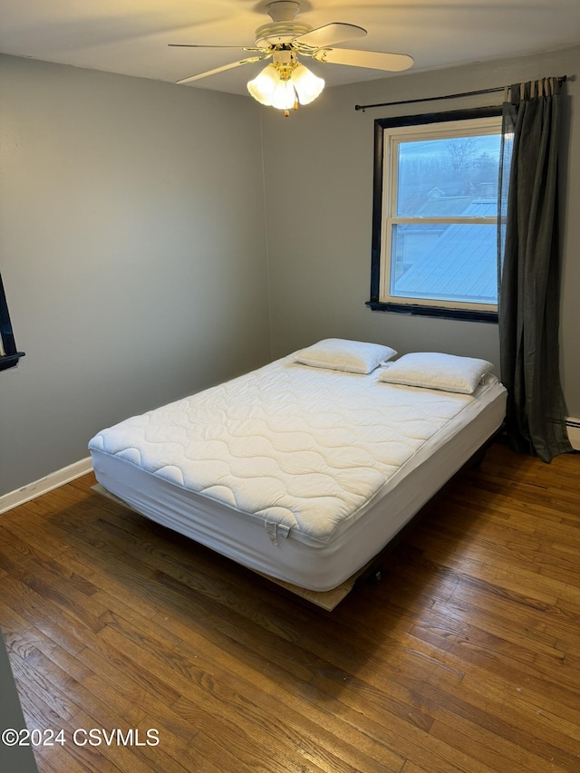 bedroom featuring dark hardwood / wood-style floors and ceiling fan