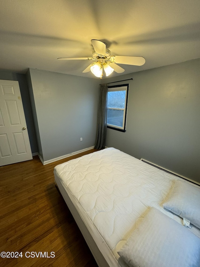 bedroom with ceiling fan and dark wood-type flooring