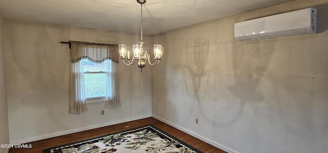 unfurnished dining area featuring dark hardwood / wood-style floors, an inviting chandelier, and a wall mounted AC