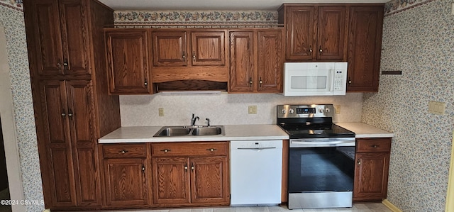 kitchen featuring sink and white appliances