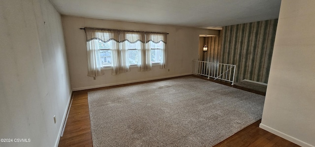 empty room with dark hardwood / wood-style floors