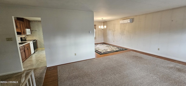 unfurnished living room featuring an AC wall unit, dark wood-type flooring, and a chandelier