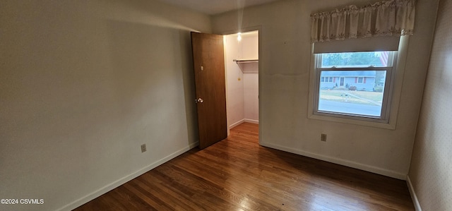 spare room with dark hardwood / wood-style flooring