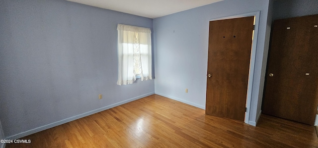 unfurnished bedroom featuring hardwood / wood-style flooring and a closet