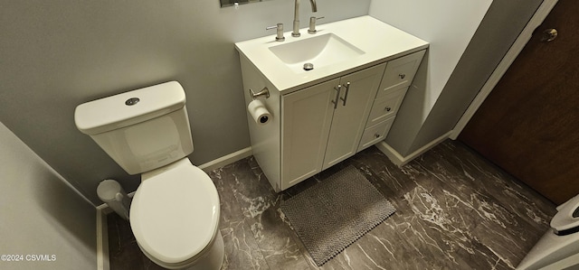 bathroom with hardwood / wood-style flooring, vanity, and toilet