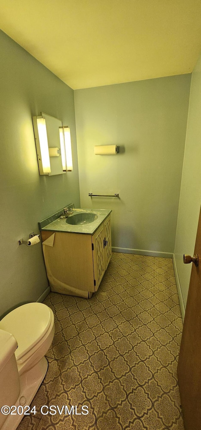 bathroom featuring vanity and toilet