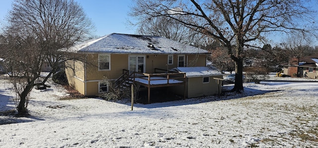 snow covered property with a deck