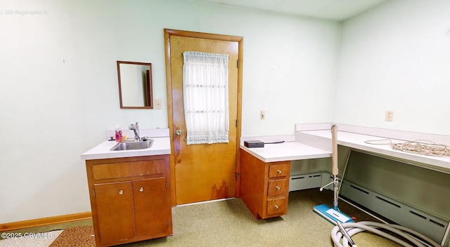 bathroom featuring sink and a baseboard heating unit