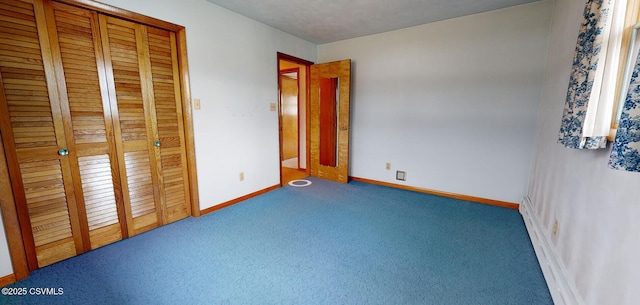 unfurnished bedroom featuring a closet and carpet floors