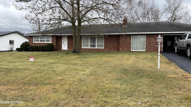 ranch-style home with a front lawn and a carport