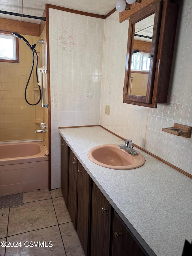 bathroom with vanity, tiled shower / bath combo, and tile patterned floors